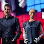 Sophia the Robot standing beside Hanson Robotics founder David Hanson on stage at Web Summit 2019 in Lisbon