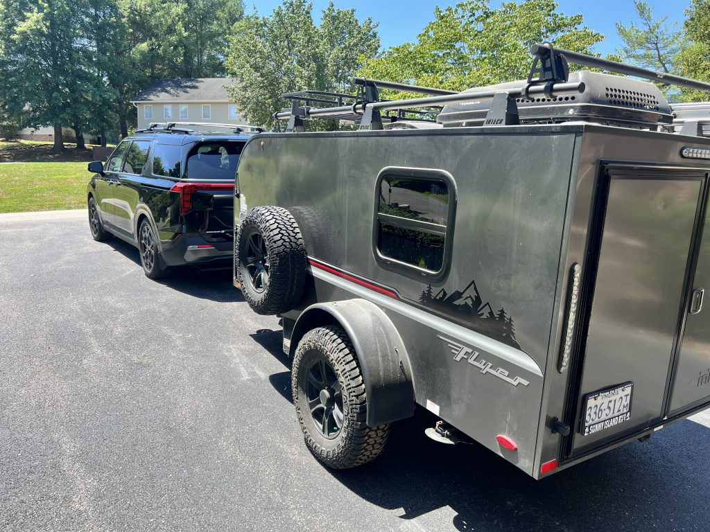 Hitched to the Carnival with the racks and rooftop carrier mounted