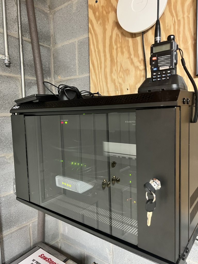 The rack holding down the fort while we're gone — local model server below, radio on top